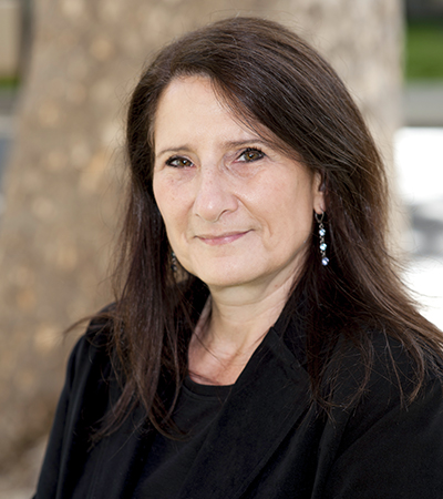 Woman shoulder length brown hair wearing a dark outfit
