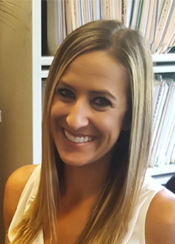 Woman with stright blonde hair wearing a white sleeveless shirt